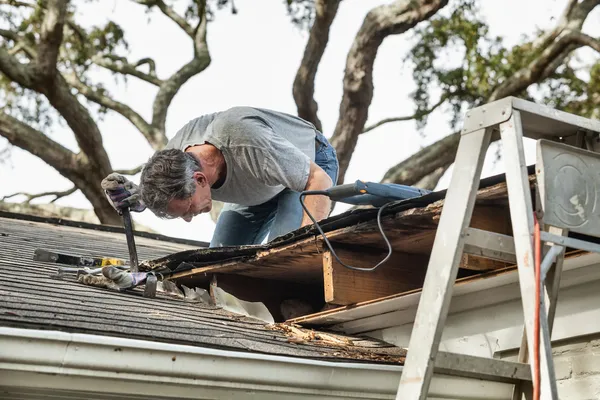 depositphotos 16970155 stock photo man examining and repairing leaking